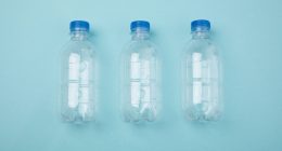 Plastic bottles on a plain blue background