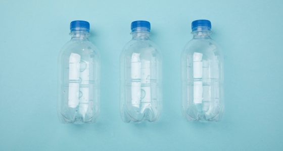 Plastic bottles on a plain blue background